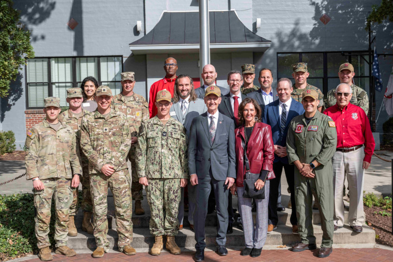 President Carter stands with military, ROTC and veterans services representatives.