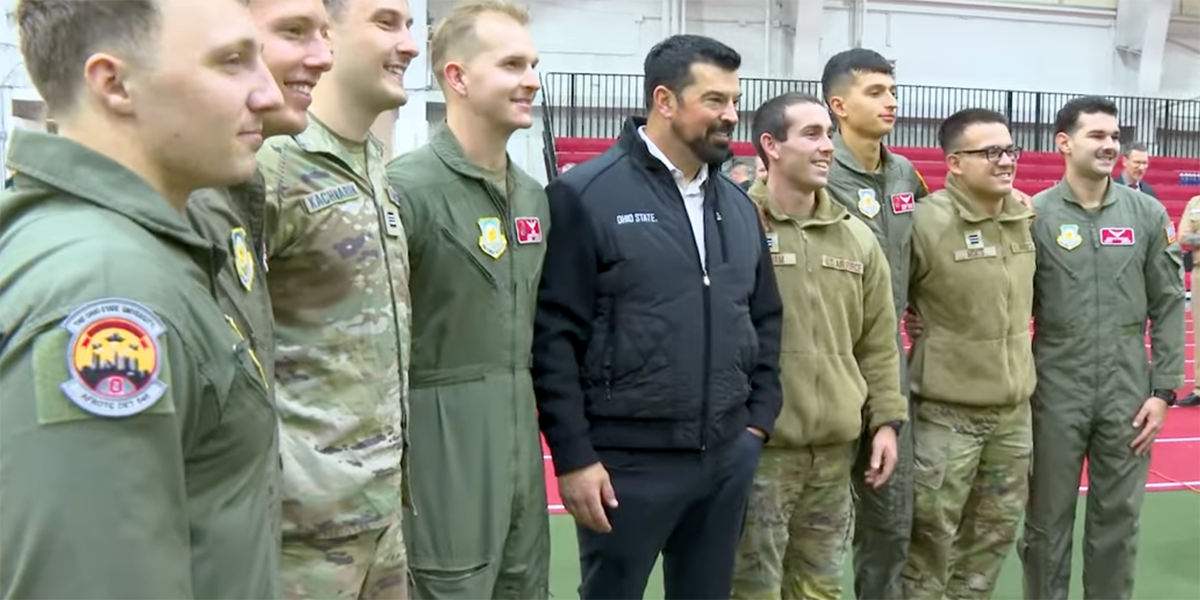 Ryan Day poses for a photo with ROTC students
