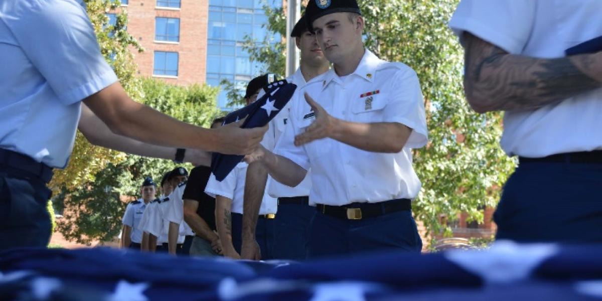 Student veterans line up to receive folded american flags