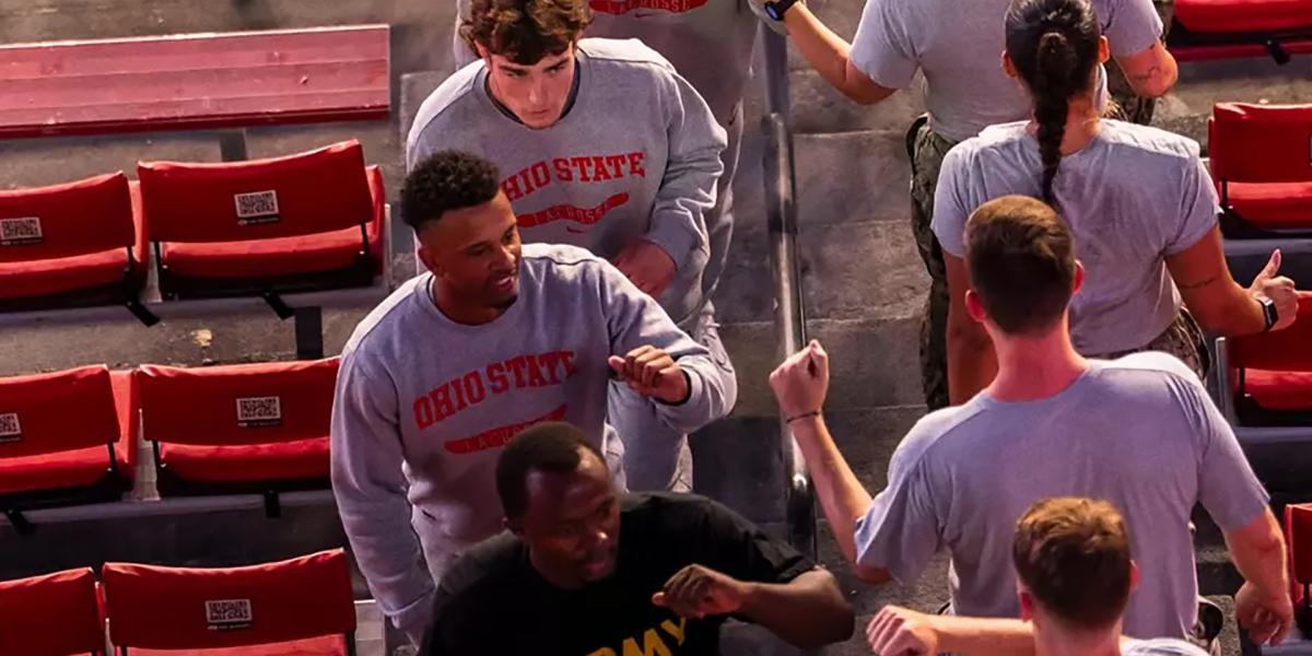 Fist bumps exchanged as participants climb the stairs of Ohio Stadium