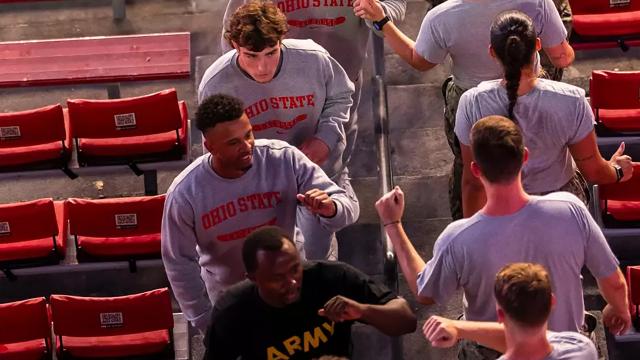 Fist bumps exchanged as participants climb the stairs of Ohio Stadium