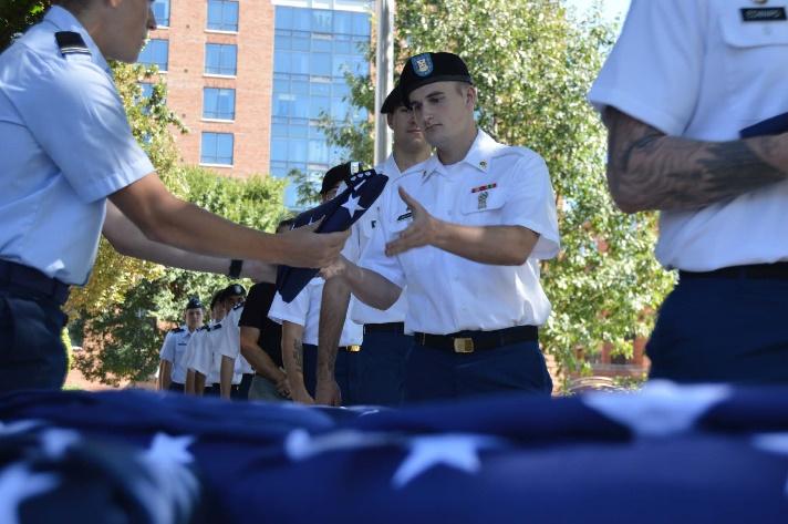 Student veterans line up to receive folded american flags