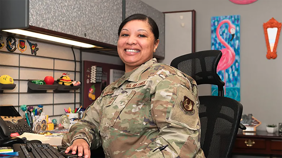 person dressed in U.S. Air Force uniform sitting in an office setting