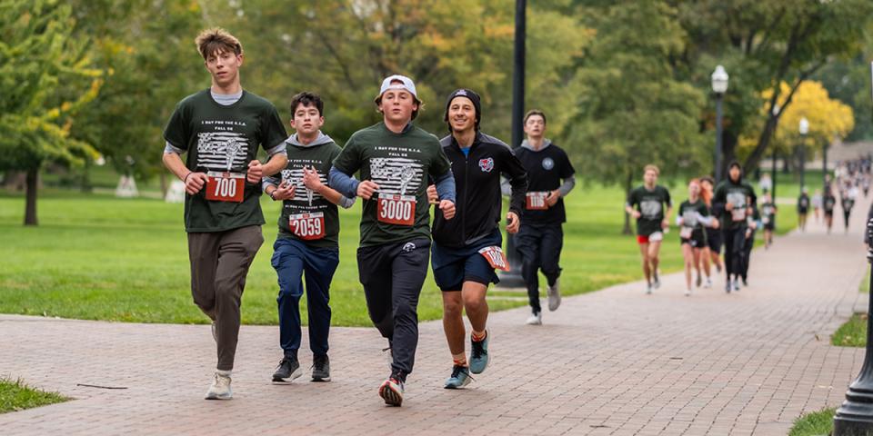 Runners on a brick path through the Ohio State campus